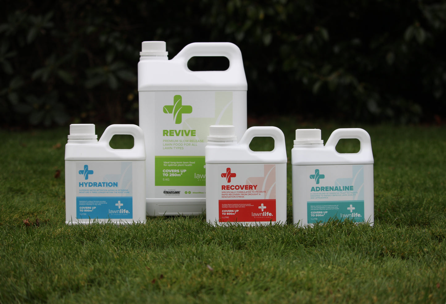 Four bottles labeled 'Hydration', 'Revive', 'Recovery', and 'Adrenaline' on grass.