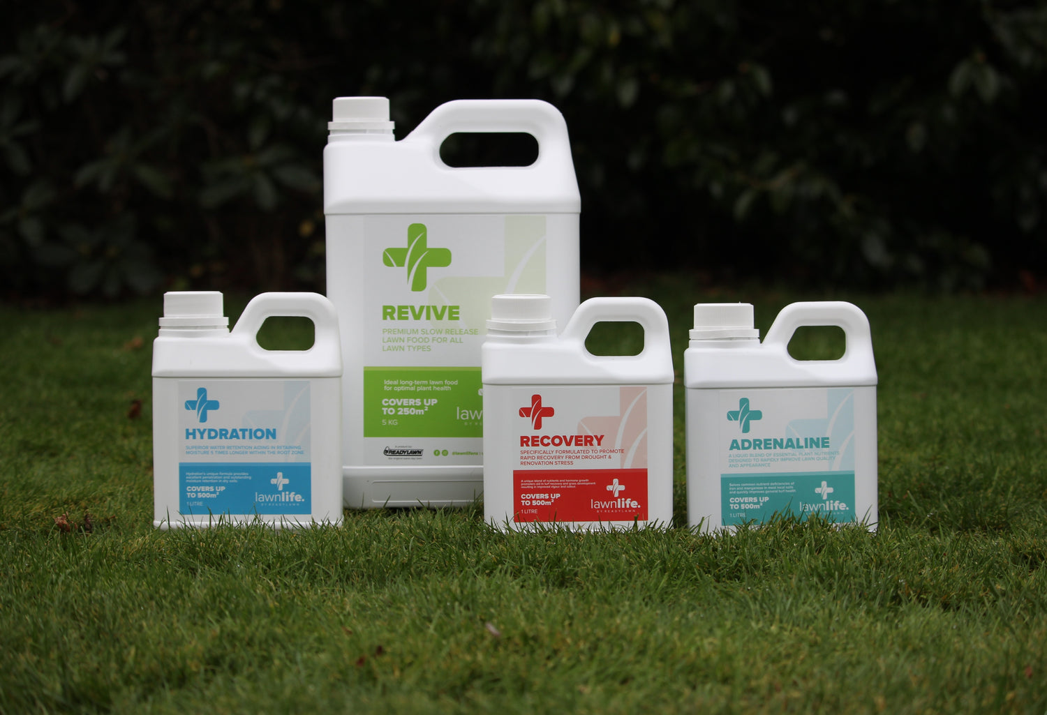 Four bottles labeled 'Hydration', 'Revive', 'Recovery', and 'Adrenaline' on grass.